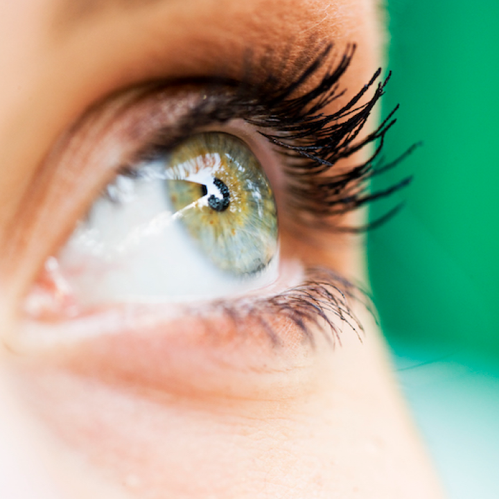 Close up of a green eye looking up