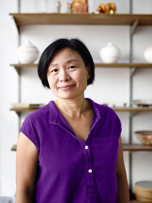 Elderly smiling woman in a purple blouse