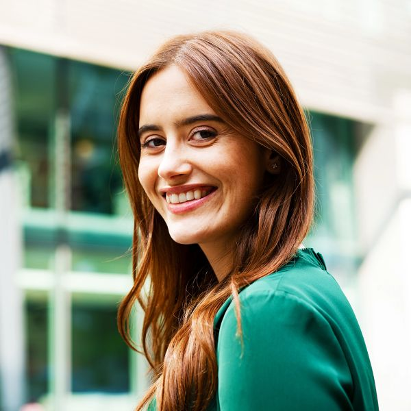 Young smiling brunette in a green blouse