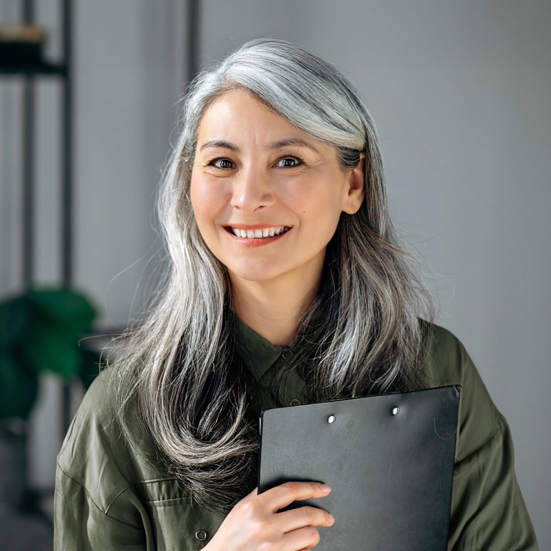 Smiling elderly woman with a notebook