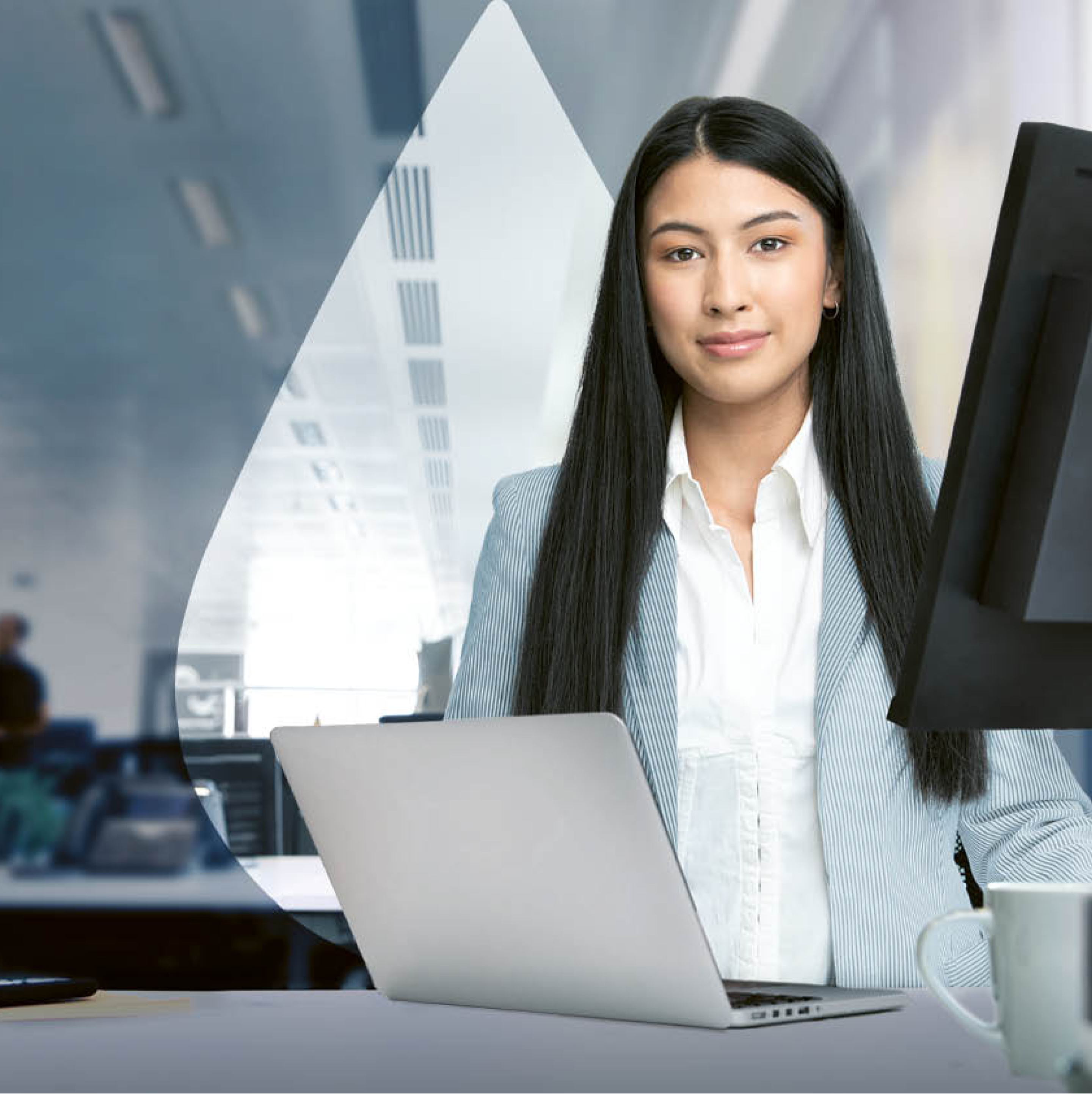 Professional woman with laptop smiling while looking at camera