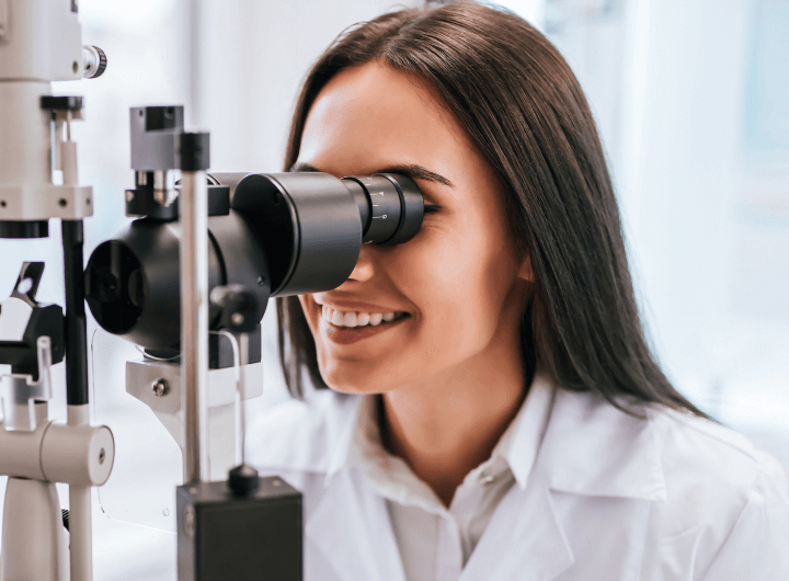 optometrist using eye exam equipment