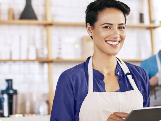 Woman working in a coffee shop with an ipad.
