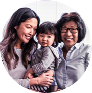 Asian mother, daughter, and grandmother smiling