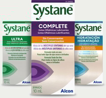 Three Systane eye drop boxes: Systane Complete (purple), Systane Ultra (green), and Systane Hidratación (blue), labeled as lubricant eye drops by Alcon.