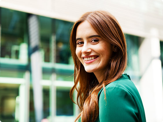 Young smiling brunette in a green blouse