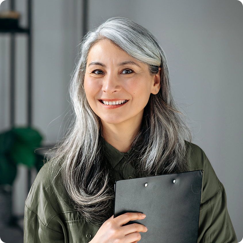 Smiling elderly woman with a notebook